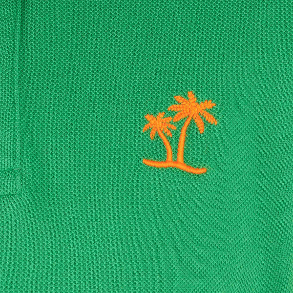 Boy green piquet polo with orange St. Barth logo