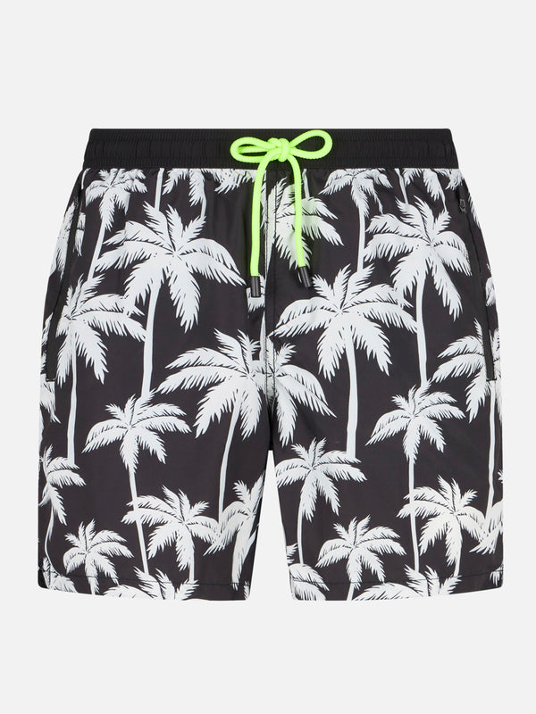 Man zipped swim shorts with palm print