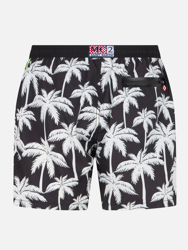 Man zipped swim shorts with palm print
