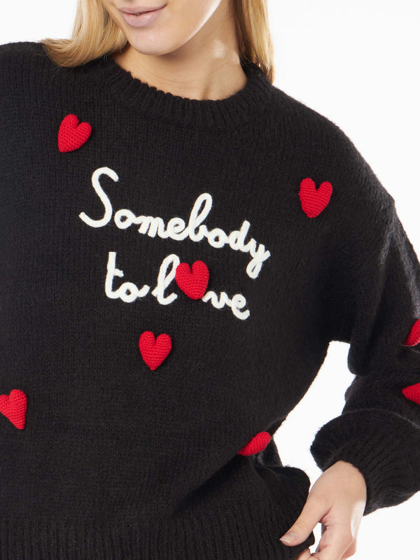 Woman boxy shape soft sweater with Somebody to Love embroidery and crochet hearts patch