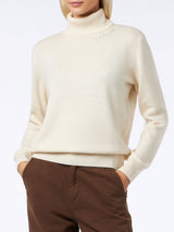 Woman knitted off white turtleneck sweater