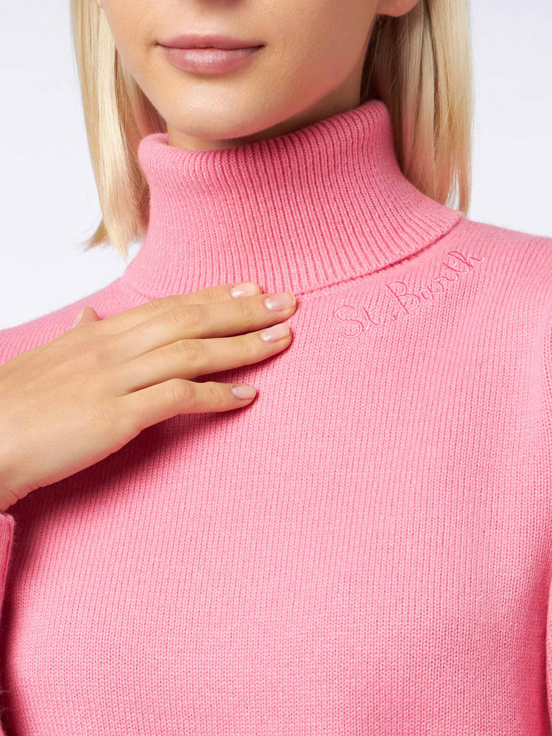 Woman knitted pink turtleneck sweater